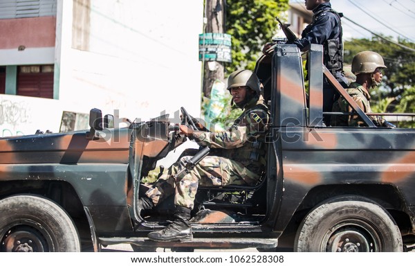 Kingston, Jamaica - 11/27/2013: Soldiers in the city\
on duty in the car
