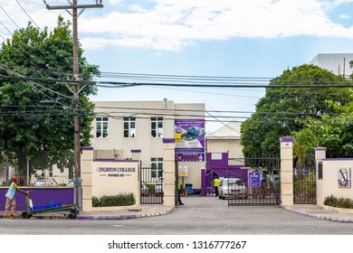 Kingston, Jamaica - February 05 2019: Entrance To Kingston College All Boys High School In Jamaica With The School Crest And Motto On The Outer Wall And A Rasta Man With Pushcart On The Street. 