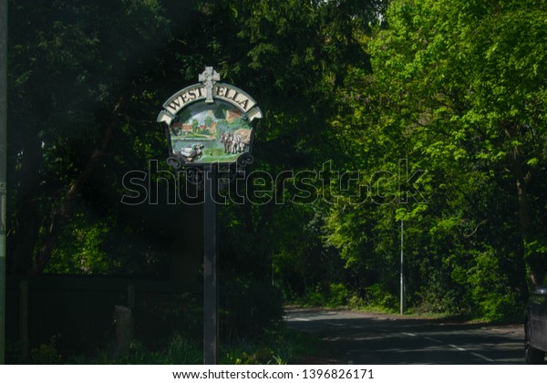 Kingston Upon Hull,\
Britain, UK - 12th May 2019: Road sign on street directing to West\
Ella, Kirk Ella, in Kingston upon Hull, East Yorkshire (City of\
Culture 2017) 
