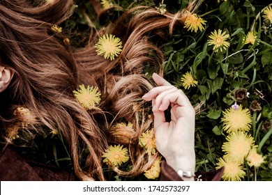 Kinky Female Brown Hair On Green Grass And Yellow Colors Of A Kulbub. Natural Hair Care