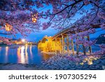 Kintaikyo Bridge in Iwakuni, Japan at  sunset with cherry blossom 