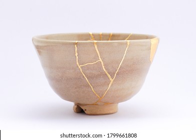 Kintsugi bowl. Gold cracks restoration on old Japanese pottery restored with the antique restoration technique.The unique beauty of imperfections. 