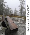 Kipari, Rautavaara, Finland, October 27 2024. A late autumn day trip to a high hill and observation tower on a foggy day. The surrounding landscape was covered in fog. Wooden bench along the route.