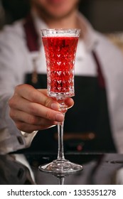Kir Royal cocktail with orange slice and ice cubes