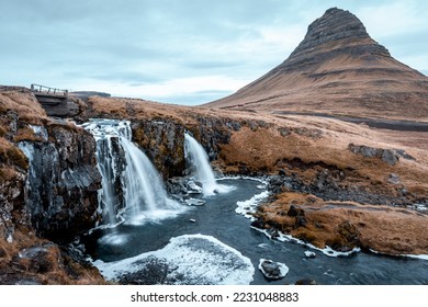 Kirkjufell mountain with waterfall in the foreground during winter