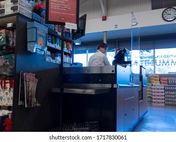 Kirkland, WA / USA - Circa April 2020: View Of A Plexiglass Barrier At A Checkout Counter, Protecting A Cashier Inside A PCC Community Market Grocery Store.