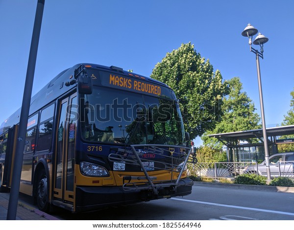 Kirkland, WA / USA -\
circa August 2020: A King County Metro bus displaying Masks\
Required on their\
marquee.