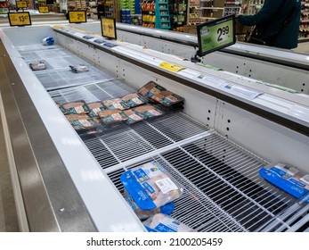 Kirkland, WA USA - circa January 2022: Angled view of food shortage in the refrigerated meats aisle in a Safeway grocery store during heavy snow storms across Washington.