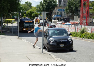 Kirkland, Washington / USA - June 1 2020: Violent agitator attempting to smash windows on a parked car