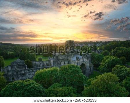 Kirkstall Abbey Ruins Illuminated by Dramatic Sunset Sky - Aerial View