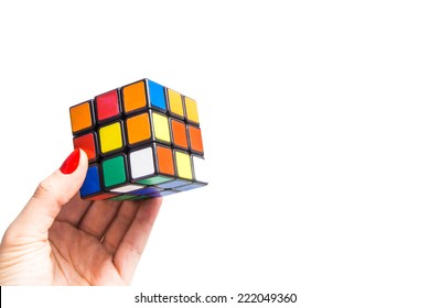 KIROV, RUSSIA - OCTOBER 06, 2014: Rubik's Cube In Hand Holding It On The White Background. Rubik's Cube Invented By A Hungarian Architect Erno Rubik In 1974.