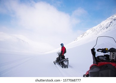 Kirovsk, Russia - 15 march 2019: Snowmobile race. Riding through the snow. Man and  snowmobile on a snow-covered Khibiny Mountains, Kola Peninsula - Shutterstock ID 1577068777
