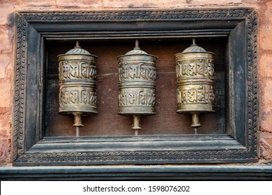 KIRTIPUR, NEPAL - OCT 29, 2019: three prayer wheels are found inside the Chilancho Bihar temple in Kirtipur, Kathmandu Valley, oct 29, 2019.