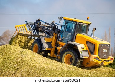 Kirwee, Canterbury, New Zealand, 5 April 2022: A local contractor uses a JCB machine to pile up maize silage for winter feed on the farm