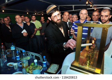 KIRYAT GAT - DECEMBER 07: Family Members Of Caramel Bus Disaster Victim Roy Bitton Light The Seventh Candle For The Jewish Holiday Hanukkah At The Mourning Tent In Kiryat Gat On December 07 2010.