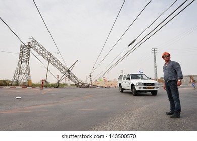 KIRYAT GAT- MAY 04 2009:Electricity Worker Of Israel Electric Corporation Looking At Toppled Overhead Power Line Caused By A Heat Wave Storm.Overhead Power Lines Are Generally The Least Costly Method 