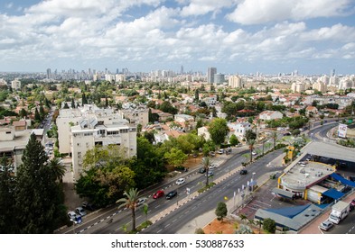 KIRYAT ONO, ISRAEL - OCTOBER 19, 2013: View from above on a city in Israel. Urban landscape from a bird's view. Top view of an Israeli city. Houses and rooftops submerged in urban nature.