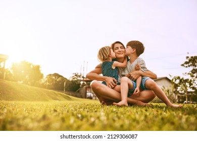 Kiss delivery for mom. Cropped shot of a young family spending time together outdoors. - Powered by Shutterstock