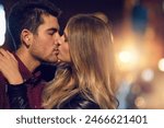 Kiss, happy couple and love at night in street for support, care and marriage with commitment. Man, woman and dates in New York with partner in city for holiday, honeymoon and urban vacation