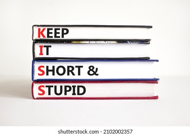 KISS keep it short and stupid symbol. Concept words KISS keep it short and stupid on books. Beautiful white table, white background. Business KISS keep it short and stupid concept. Copy space.