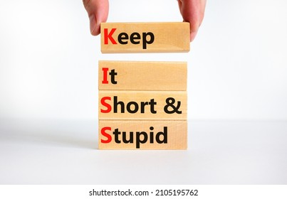 KISS keep it short and stupid symbol. Concept words KISS keep it short and stupid wooden blocks. Beautiful white table, white background. Business KISS keep it short and stupid concept. Copy space.