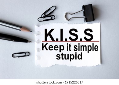 KISS, keep it simple, stupid. text on white paper on gray background