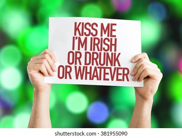 Kiss Me Im Irish Or Drunk Or Whatever placard on bokeh background