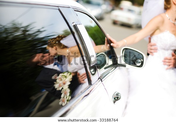 kiss in the reflection of a\
car