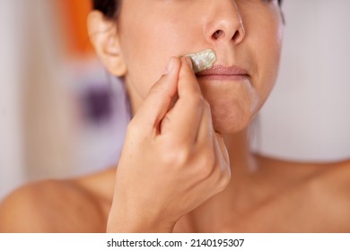 Kissable Lips In The Making. Shot Of A Woman Waxing Her Upper Lip.