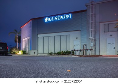 Kissimmee, Florida - February 6, 2022: Horizontal Night View Of BurgerFi Restaurant Building Back Food Supply Entrance.