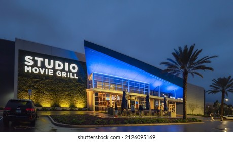 Kissimmee, Florida - February 6, 2022: Night Wide Angle View Of Studio Movie Grill Building Exterior. It Is A Big Modern Movie Theater.