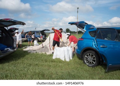 Kissimmee, Florida / USA - August 29, 2019: Osceola County Florida Residents Fill And Load Sandbags At Osceola County Heritage Park In Preparation For Hurricane And Tropical Storm Dorian 