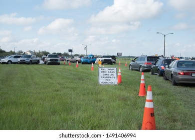 Kissimmee, Florida /USA -August 29, 2019: Cars Waiting In Line By Fill Your Own Sandbag Sign With Limit 25 Per Household In Osceola County FL Heritage Park In Prep For Hurricane Tropical Storm Dorian