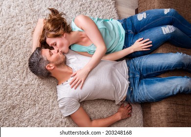 Kissing Couple Couch Floor Lying Down In New Home