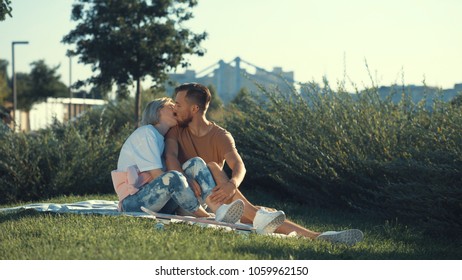 Kissing happy couple in a summer park - Shutterstock ID 1059962150