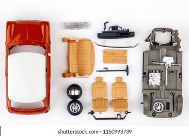 Kit For Assembling Gray Plastic Car Model On White Background