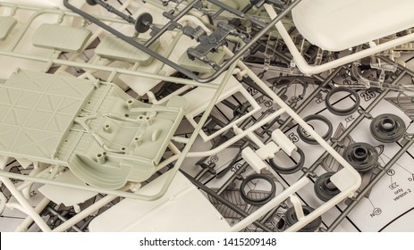 Kit For Assembling Gray Plastic Car Model On White Background