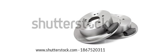 kit of brake pads with brake discs new spare parts brakes for a car isolated on a white background horizontal banner with copy space, nobody.