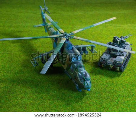 KIT model. Scale model of a helicopter, plastic toy, on a green background