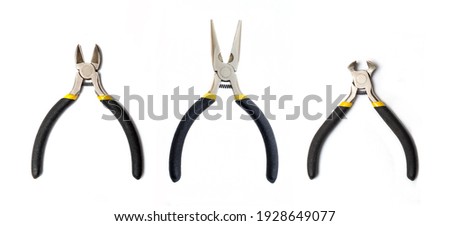 Kit pliers tools with black rubber handles for the master electrician on white background