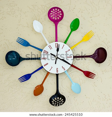 Kitchen abstract clock witch spoon and fork.