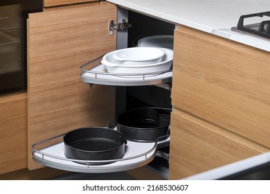 Kitchen access mechanism Magic corner for Blind Corner Cabinets. Solution for a kitchen corner storage in cupboard. Corner unit with pull out shelves for cookware. - Shutterstock ID 2168530607