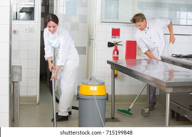 Kitchen Aids Are Cleaning The Restaurant Kitchen