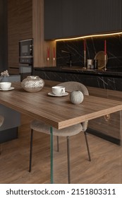 Kitchen Area In A Chic Expensive Interior Of A Luxury Home With A Dark Black And Brown Modern Design With Wood Trim And Led Light