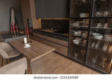 Kitchen Area In A Chic Expensive Interior Of A Luxury Home With A Dark Black And Brown Modern Design With Wood Trim And Led Light