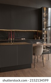 Kitchen Area In A Chic Expensive Interior Of A Luxury Home With A Dark Black And Brown Modern Design With Wood Trim And Led Light