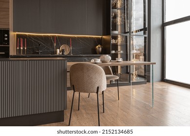 Kitchen Area In A Chic Expensive Interior Of A Luxury Home With A Dark Black And Brown Modern Design With Wood Trim And Led Light