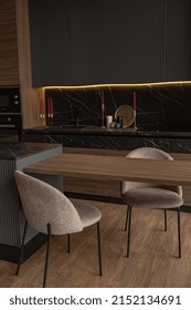 Kitchen Area In A Chic Expensive Interior Of A Luxury Home With A Dark Black And Brown Modern Design With Wood Trim And Led Light