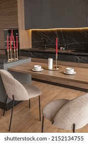 Kitchen Area In A Chic Expensive Interior Of A Luxury Home With A Dark Black And Brown Modern Design With Wood Trim And Led Light