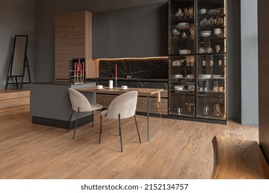 Kitchen Area In A Chic Expensive Interior Of A Luxury Home With A Dark Black And Brown Modern Design With Wood Trim And Led Light